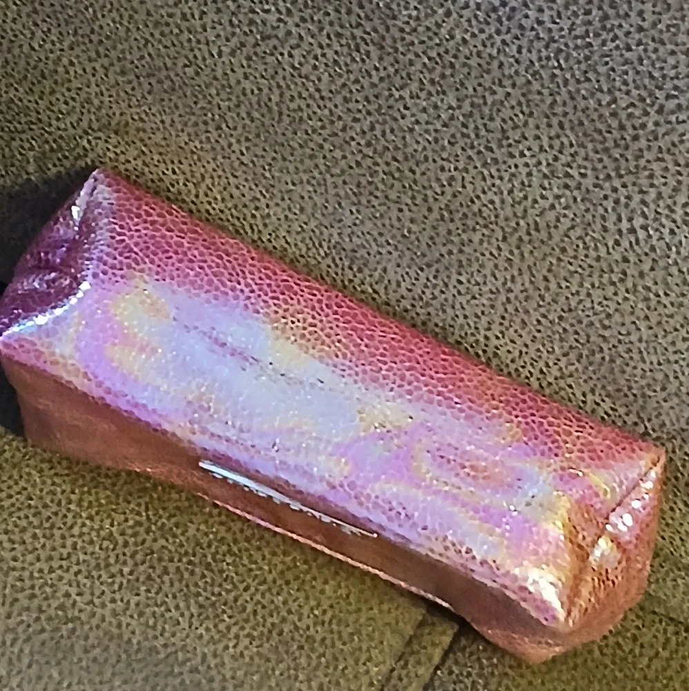 SeneGence pink holographic makeup bag with skin care and gloss samples